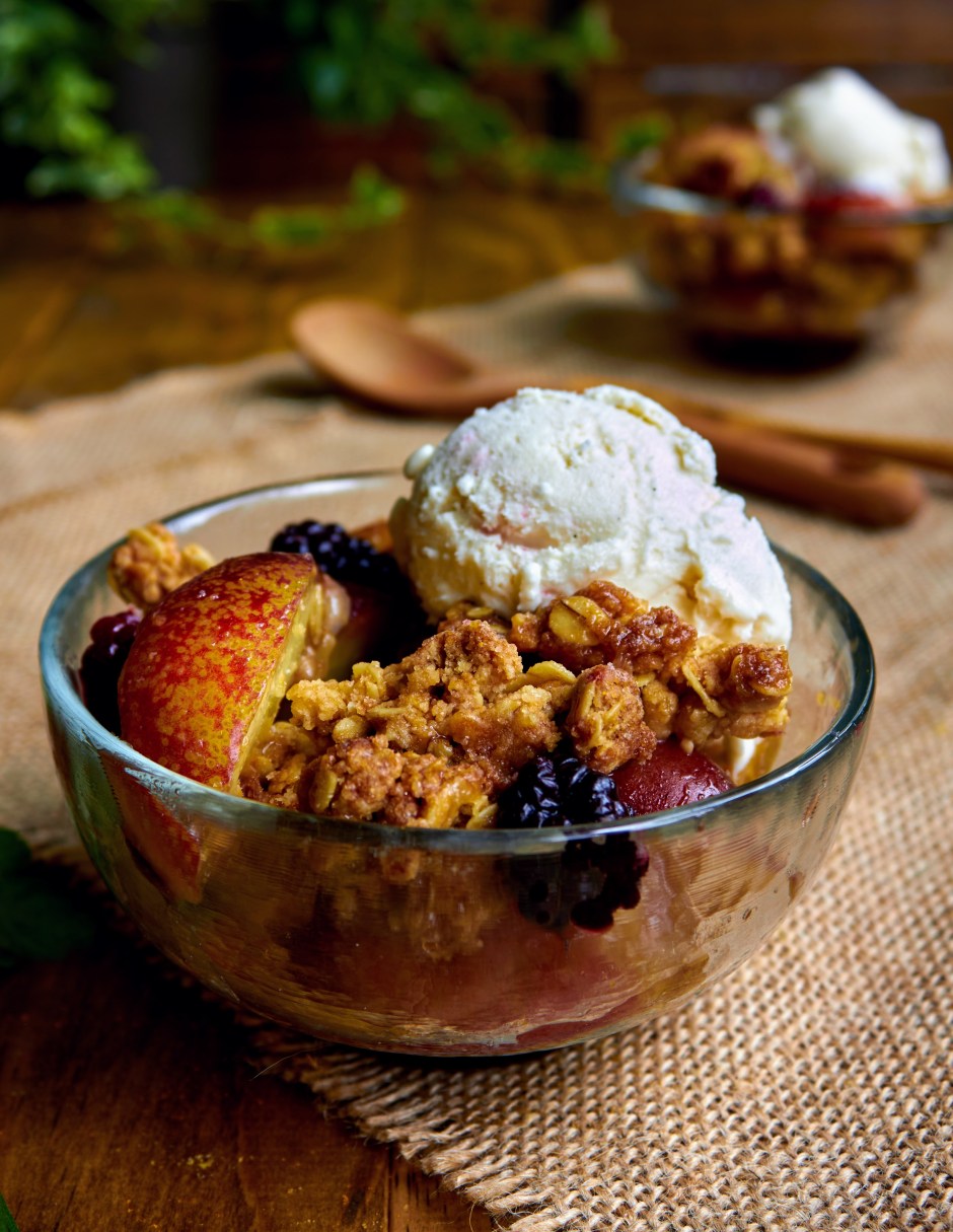 nectarine crisp with oat streusel topping and a scoop of vegan vanilla ice cream